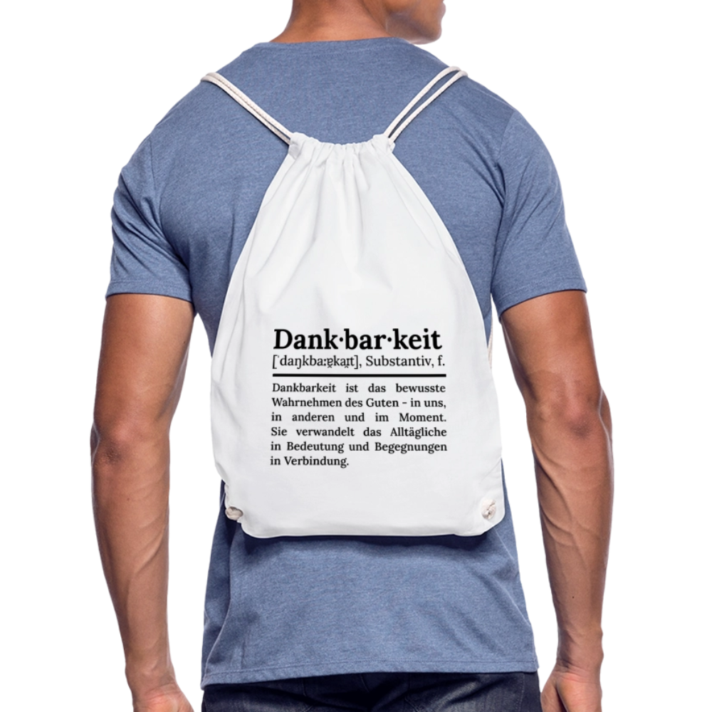 Getragener Design-Turnbeutel „Dankbarkeit“ in weiß aus Bio-Baumwolle. Nachhaltiger Stoffbeutel als treuer Alltagsbegleiter.